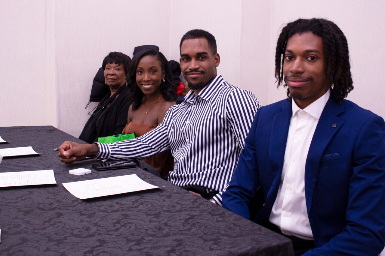 4 Members of the Steele family, sitting at the concessions table