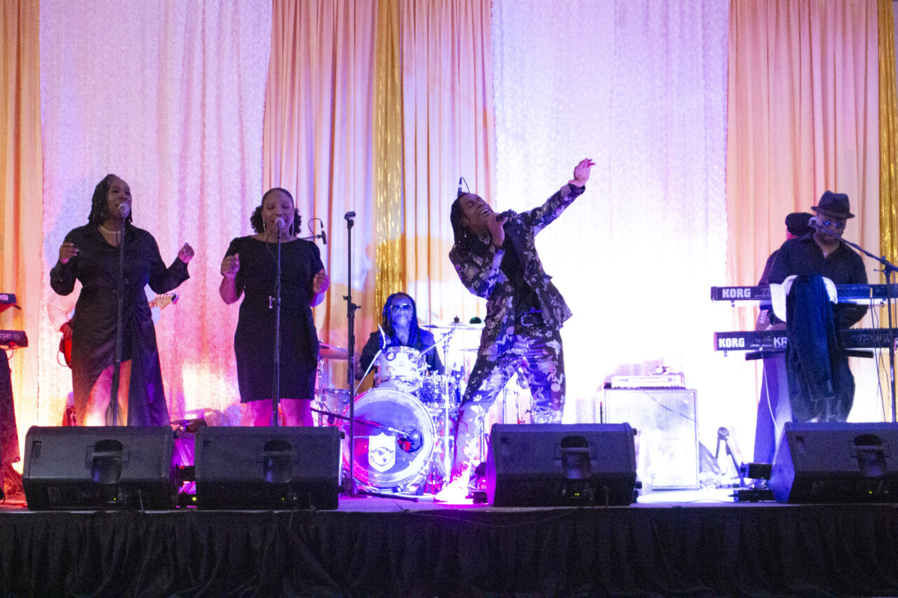 Mark Steele Sr. performing onstage with The Hardcore Band and backup singers